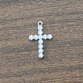 Macro view of silver cross pendant with granular relief and polished top ring - Silver Cross Pendant Only