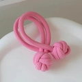 Pink elastic braided hair tie with double knots placed on a white ceramic plate - 1 Piece / Pink