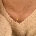 Elegante collar con colgante de corazón dorado para mujer con circonitas sobre jersey - Dorado