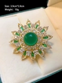 Detail view of gold sunflower brooch with green crystal and zircon in a gift box - Green Sunflower (TB1524)