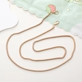 Detailed view of a golden metal snake bone chain strap with lobster clasps on each end - 4.2mm Gold Snake Chain