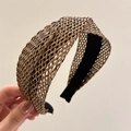 Detail of woven brown raffia headband showing intricate cross-knit texture and inner lining - Coffee