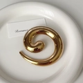 Macro view of spiral golden stainless steel brooch with a high-polished mirror finish - 9# Gold Spiral Circle Brooch