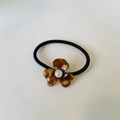 Floral hair tie featuring tortoiseshell acetate petals and a centered white faux pearl - Caramel color