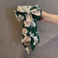 Vintage dark green floral bow hair clip with white and pink blossoms on display card - Dark Green Camellia Print Ribbon