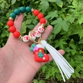 Detail of Christmas beaded wristlet keychain with Santa sock charm and white tassel - Style 5 (Red Christmas Stocking)