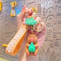 Cute Capybara keychain holding a turtle with an orange Luck Day strap and gold ring - Resin Capybara - Turtle