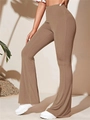 Detail view of brown high-waisted ribbed knit yoga flare pants with elegant vertical texture - S / Bottoms / Camel