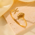 Golden stainless steel open cuff bracelet featuring sea star and seashell ornaments - Gold Ocean Starfish
