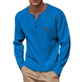 Detail of blue waffle knit Henry shirt with buttoned neckline and small leather patch - Sapphire Blue