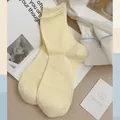 Pale yellow cotton ribbed mid-tube socks in a minimalist Morandi style aesthetic - One Size / Light Yellow