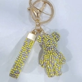 Macro shot of lemon yellow crystal rhinestone bear keychain with gold metal clasp detail - Imperial Yellow Mix