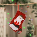Red Christmas stocking with plush Santa Claus and snowflake motifs on holiday tree - Medium Santa Body Sock