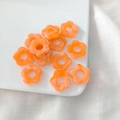 DIY handmade orange acrylic five-petal flower charms on a white display plate - Orange Marbled 2