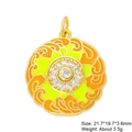 Macro shot of gold circular pendant with orange enamel and cubic zirconia stones - Orange Yellow Disc