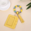 Detail of yellow wave-edge PU card holder with silicone bead wristlet and tassel - Yellow