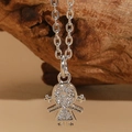 Macro shot of silver ballerina pendant with sparkling zircons on a wooden background - Silver Style 2 (XL2473)