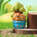 Cute yellow bear figurine resting by a tree stump on a blue Relax Club base - A187 Relax Bear