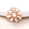 Golden flower accessory with white pearls and marquise crystals on a bright background - White