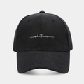 Close-up of white 'whatever' script embroidery on a black brushed fabric baseball cap - Adjustable / Black