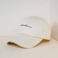 Detail of off-white baseball cap featuring black freedom cursive embroidery texture - One Size / Beige
