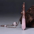 Macro shot of rose quartz pendulum with vintage copper hollow pattern and crystal beads - Antique Bronze Rose Quartz