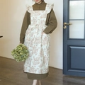Vintage beige floral cotton apron with ruffles and toile pattern shown on model - Rice and Brown Toile