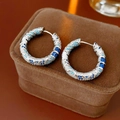 Macro shot of silver vintage round earrings with spiral blue zircon stones and detail - 74# Ear Buckle-Silver-Blue
