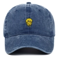 Detail shot of melting yellow smiley face embroidery on washed blue denim baseball cap - Adjustable / Navy Blue
