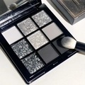 Detailed view of 9-color matte and glitter eyeshadow palette with a makeup brush - No. 11 Cool Black White Grey Silver