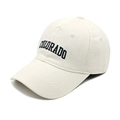 Close-up of black COLORADO letter embroidery on a cream washed cotton baseball cap - M (56-58cm) / White