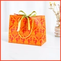 Elegant red gift paper bag with yellow floral damask patterns and a green satin ribbon bow - Red (Green Ribbon)