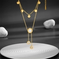 Double-layer gold stainless steel necklace with shell pendants on a white rippled plate - Gold