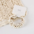 Detail of elegant handmade pearl scrunchie with cream beads on display card - Card Packaging / Off White