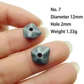 Detailed view of 12mm dark gray irregular geometric alloy spacer bead held by fingers - Size 7