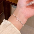 Elegant silver star pendant bracelet with shimmering zircon stones worn on wrist - S693 Silver