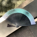 Chinese folding fan featuring a gradient green bamboo pattern and black carved ribs - Hollow Bamboo Node Green Bamboo
