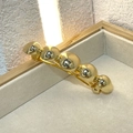 Elegant golden metallic spring hair clip with five polished gradient beads on a display tray - Round Gold