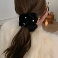 Elegant large pearl on black velvet scrunchie shown on a woman's hair in a back view - Black Velvet With Pearls