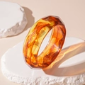 Detail of amber acrylic bangle with geometric facets showing light refraction and texture - Dark Coffee Faceted Bangle (90#)