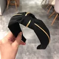 Elegant wide black knotted headband featuring golden tube accents for a chic hair accessory - Black