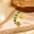 Golden titanium steel open ring with wavy texture and six green round gemstones - Adjustable Open / JOM25030-Gold Multiple Round Green Stones