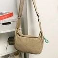 Water-resistant nylon messenger bag in beige with adjustable strap and green zip puller - Khaki