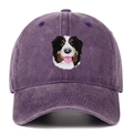 Close-up of Bernese Mountain Dog embroidery on a purple washed denim baseball cap - Purple