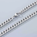 Macro shot of silver stainless steel Cuban link chain with lobster clasp and polished finish - 6.6mm Width-Lobster Clasp-45cm Length