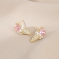 Macro shot of gold ice cream stud earrings with pink heart stone and zircon pave - Gold