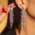 Elegant silver long tassel earrings with sparkling pink rhinestones on a model display - 3D Style / Pink and Silver