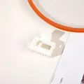 Close-up of minimalist white matte hair claw clip on table with aesthetic props - Matte Cream White