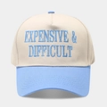 Close-up of high-quality EXPENSIVE & DIFFICULT embroidery on a two-tone baseball cap - Adjustable / Beige/Blue
