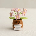 Handmade crochet emotional support plant doll with a pink flower and encouraging sign - Forget-Me-Not Pink